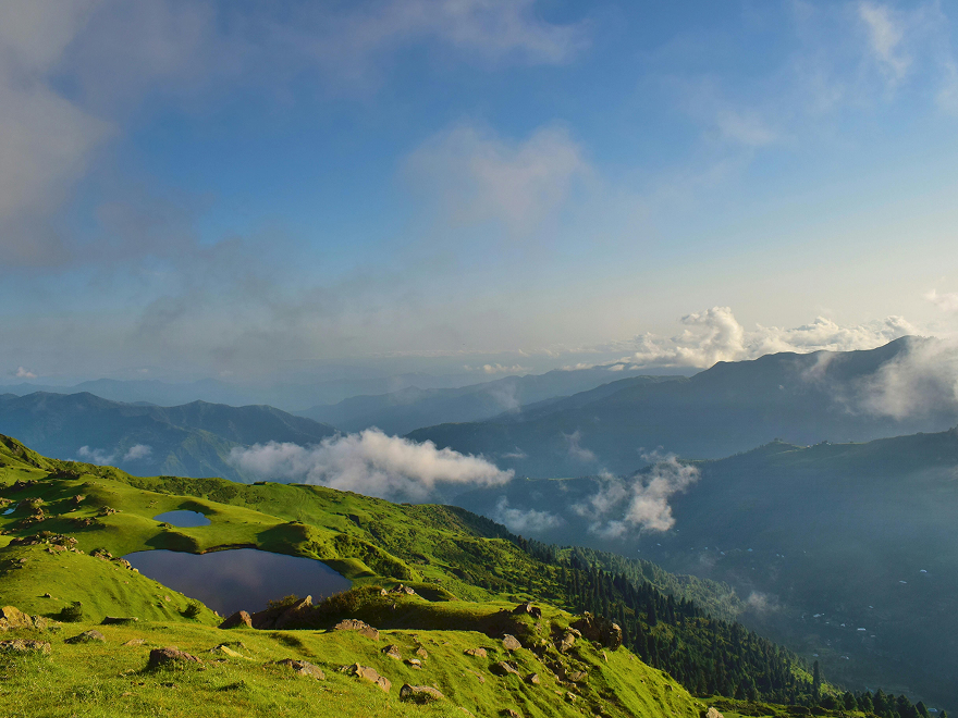 Mountain landscape with green hills and clouds